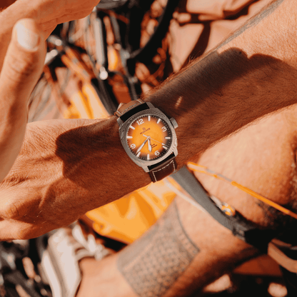 A close-up lifestyle shot of the McQuaide C1 Sunburst worn on a person's wrist.