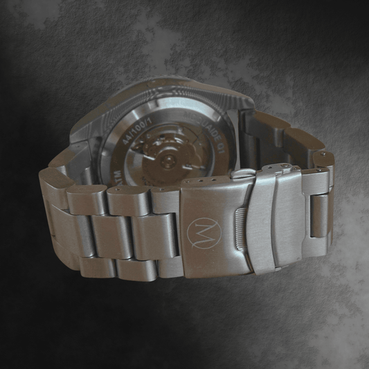 Damascus Steel watch with a detailed brushed steel bracelet on a dark textured background